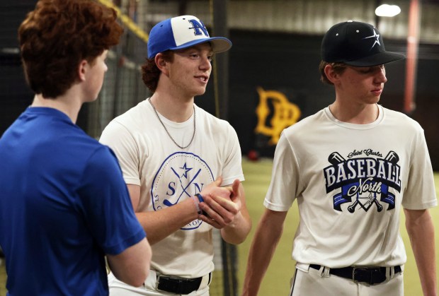 St. Charles North shortstop Jackson Spring, center, talks with teammates Mason Netcel, left and Henry Grimm after practice at the Dirtbags workout facility on Wednesday, March 20, 2024 in South Elgin.H. Rick Bamman / For the Beacon-News