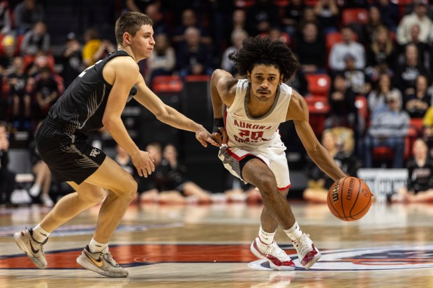 Aurora Christian's Jalen Carter (20) drives past West Central's Mason Berry (2) during the Class 1A state semifinals at the State Farm Center in Champaign Thursday, March 7, 2024. (Vincent D. Johnson/for the Beacon-News)