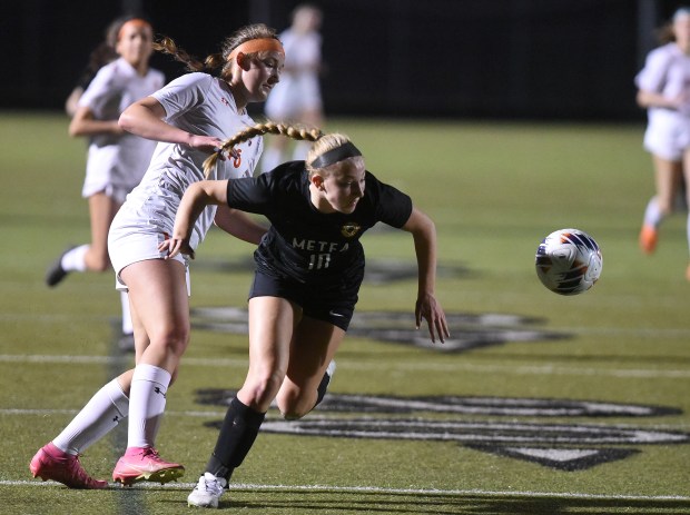 Metea Valley's Mckenna Wigfield (10) tries to get to the goal against Oswego's Peyton Johnson (16) during a nonconference game Tuesday, March 12, 2024 in Aurora, IL. (Steve Johnston/for the Beacon-News)