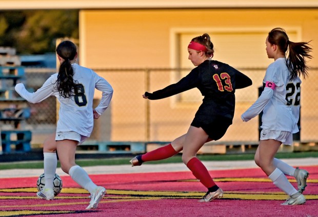 Batavia's Abi Edwards scores her first goal of the game despite the efforts of Streamwood's Marisol Esparza and Sharon Salazar. Batavia defeated Streamwood 7-0 in a girls soccer match, Thursday, March 21, 2024, in Batavia, Illinois. (Jon Langham/for the Beacon-News)