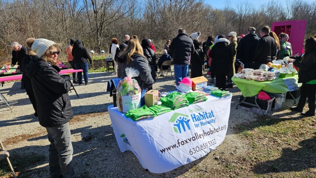 A crowd came out for the groundbreaking on Saturday of the first home in the new Habitat for Humanity Green Freedom subdivision in Aurora, which will feature 17 net-zero-energy houses. (David Sharos / For The Beacon-News)