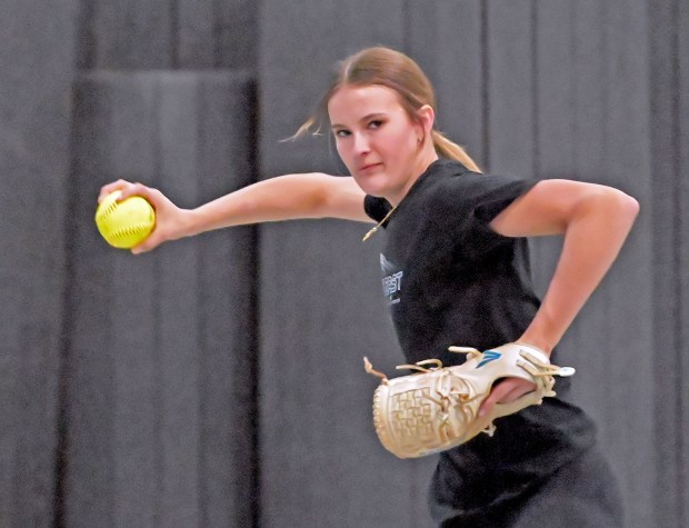 Oswego East's Ronnie Craft plays catch as she practices indoors. Oswego East's softball game with Metea Valley was postponed due to weather, so the home team practiced indoors, Friday, March 22, 2024, in Oswego, Illinois. (Jon Langham/for the Beacon-News)