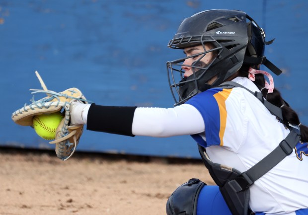 Aurora Central Catholic's Sophia Delgado (2) secures a Corina Miller pitch for a strike during a non conference game against Trinity on Wednesday, March 27, 2024 in Aurora.H. Rick Bamman / For the Beacon-News