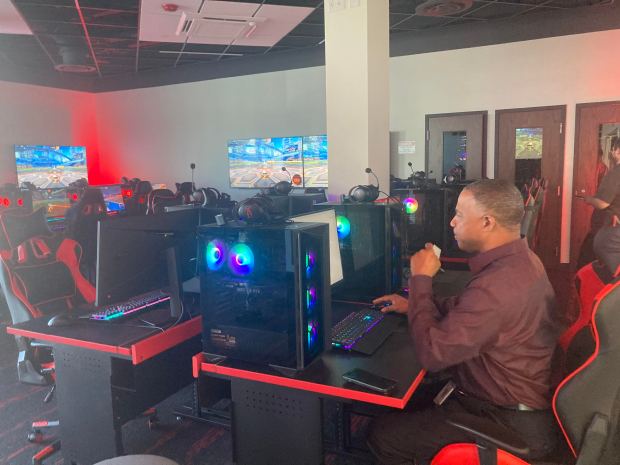 Kevin Jenkins, safety and security manager for East Aurora School District, works at one of the gaming stations in the E-sports Center of the district's new Resilience Education Center