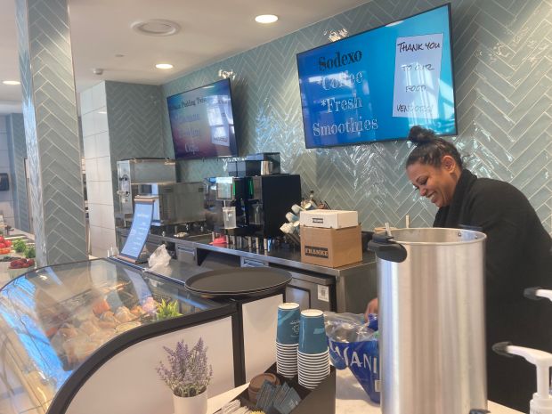 An employee with Sodexo Food Service works behind the counter of the coffee bar prior to the ribbon-cutting ceremony Wednesday for East Aurora School District's new Resilience Education Center. (Denise Crosby / The Beacon-News)