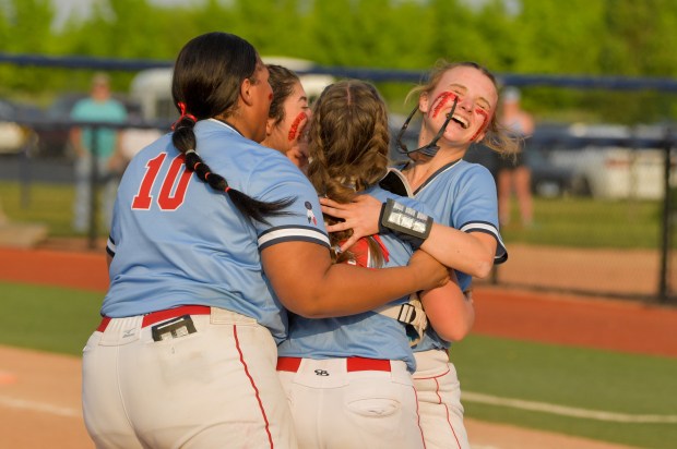 West Aurora celebrates with pitcher Katelyn Serafin (14) after she struck out the final batter against Oswego during the Class 4A West Aurora Regional semifinals at Aurora University's Spartan Athletic Park on Tuesday, May 23, 2023.