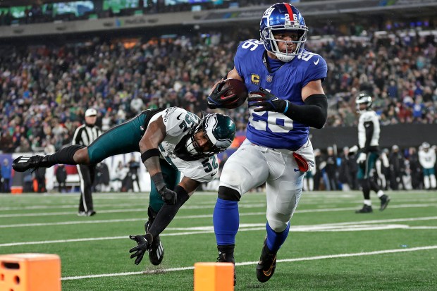 Giants running back Saquon Barkley rushes for a touchdown against the Eagles on Jan. 7, 2024, in East Rutherford, N.J. (Adam Hunger/AP)