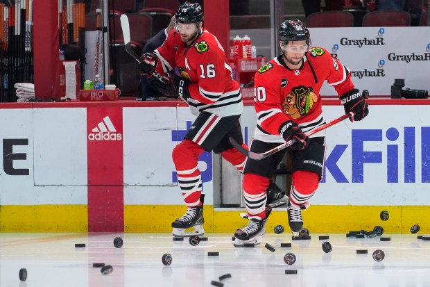 Chicago Blackhawks center Tyler Johnson, right, and center Jason Dickinson warm up for the team's NHL hockey game against the Philadelphia Flyers, Wednesday, Feb. 21, 2024, in Chicago. (AP Photo/Erin Hooley)