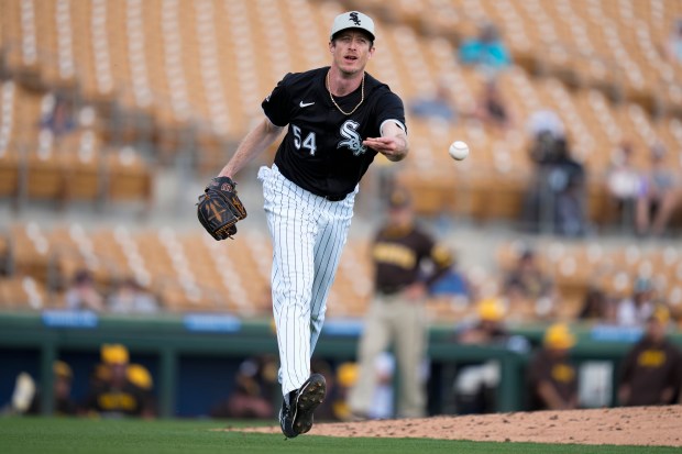 Chicago White Sox relief pitcher Tim Hill throws to first to out San Diego Padres' Brett Sullivan during the fifth inning of a spring training baseball game in Phoenix, Wednesday, Feb. 28, 2024. (AP Photo/Ashley Landis)