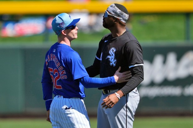 Chicago Cubs' Pete Crow-Armstrong (52) talks with Chicago White Sox's Eloy Jiménez prior to a spring training baseball game, Friday, March 1, 2024, in Mesa, Ariz. (AP Photo/Matt York)