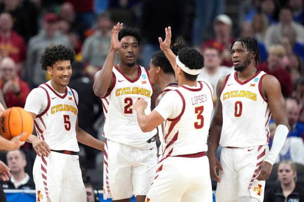 Iowa State's Hason Ward is congratulated by teammate Tamin Lipsey (3) as Curtis Jones (5) and Tre King (0) look on during the first half of a first-round college basketball game against South Dakota State in the NCAA Tournament Thursday, March 21, 2024, in Omaha, Neb. (AP Photo/Charlie Neibergall)