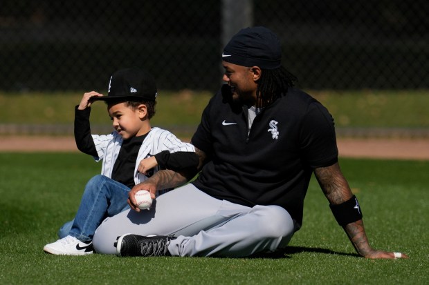 White Sox catcher Martín Maldonado plays with his son, Aiden, at spring training at Camelback Ranch on Feb. 15, 2024. (Ashley Landis / AP)