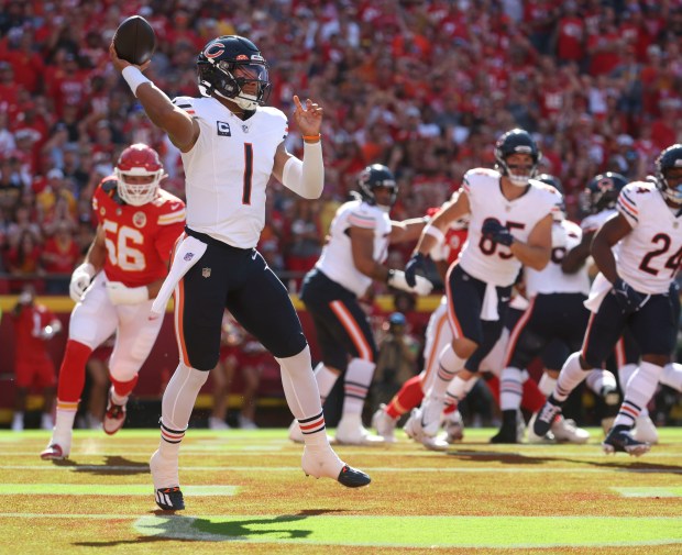 Bears quarterback Justin Fields scrambles in the end zone away from Chiefs defensive end George Karlaftis (56) in the first quarter on Sept. 24, 2023, at Arrowhead Stadium.