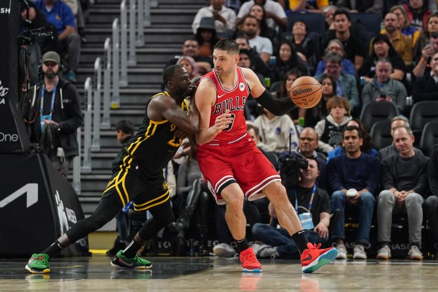 Nikola Vucevic dribbles the ball in the second quarter against the Warriors' Draymond Green on March 7, 2024. (Kavin Mistry/Getty Images)