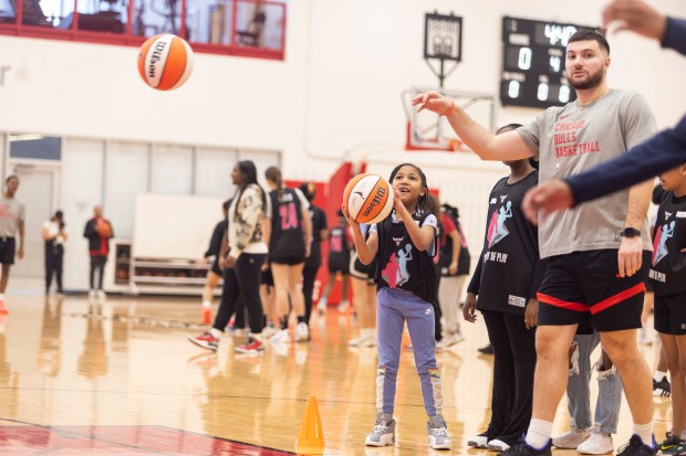 Girls take turns at different skill stations with help from Chicago Bulls staff during the Girls' Day of Play? clinic at the Advocate Center Sunday, March 3, 2024, in Chicago. (Vincent D. Johnson/for the Chicago Tribune)