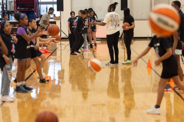 Girls take turns at different skill stations with help from Chicago Bulls staff during the Girls' Day of Play? clinic at the Advocate Center Sunday, March 3, 2024, in Chicago. (Vincent D. Johnson/for the Chicago Tribune)