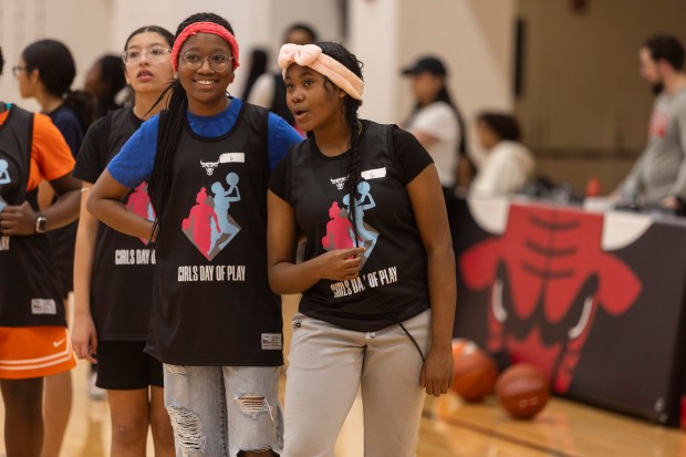 Lauren, right, talks with another participant during skills drills at the Girls' Day of Play? clinic at the Advocate Center Sunday, March 3, 2024, in Chicago. (Vincent D. Johnson/for the Chicago Tribune)