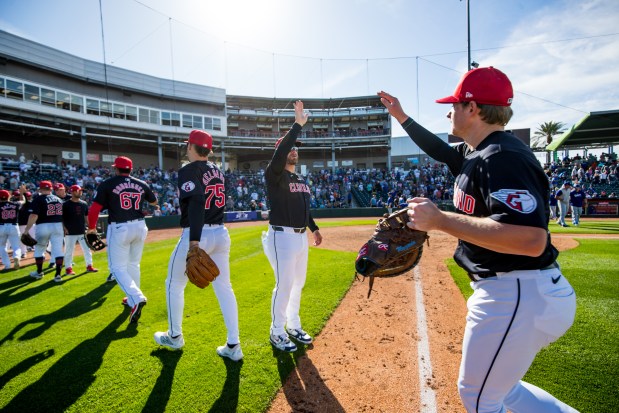 Guardians manager Stephen Vogt high-fives players after a spring training game against the Dodgers at Goodyear Ballpark on March 11, 2024. (John E. Moore III/Getty Images)