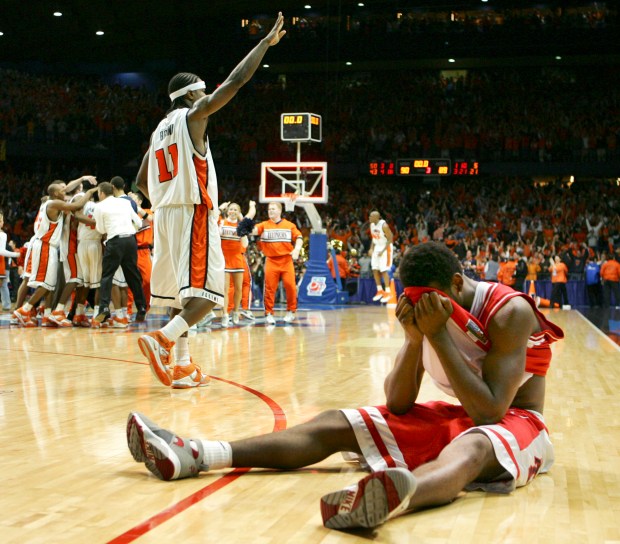 Arizona's Jawann McClellan reacts on the court as Illinois' Dee Brown (11) and teammates celebrate their 90-89 overtime win in the Chicago Regional championship game of the NCAA tournament Saturday, March 26, 2005, at the Allstate Arena in Rosemont, Ill. (AP Photo/Jeff Roberson)