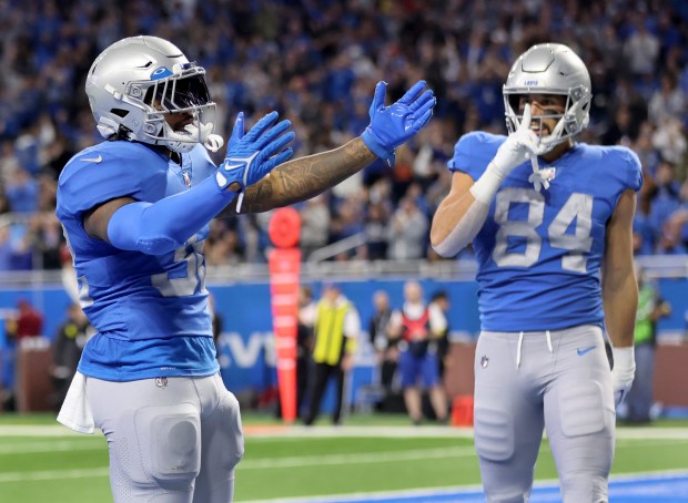 Lions running back D'Andre Swift celebrates after scoring a touchdown against the Bears on Jan. 1, 2023, at Ford Field in Detroit. (Chris Sweda/Chicago Tribune)