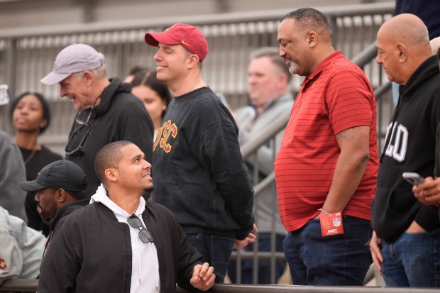 Bears general manager Ryan Poles, left, speaks with Carl Williams, father of USC quarterback Caleb Williams at the school's pro day on Wednesday, March 20, 2024, in Los Angeles. (AP Photo/Ryan Sun)