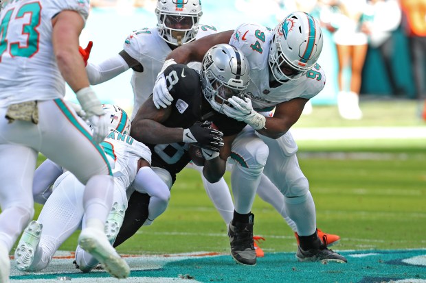 Dolphins defensive tackle Christian Wilkins tackles Raiders running back Josh Jacobs on Nov. 19, 2023 in Miami Gardens, Fla. (John McCall/South Florida Sun Sentinel)