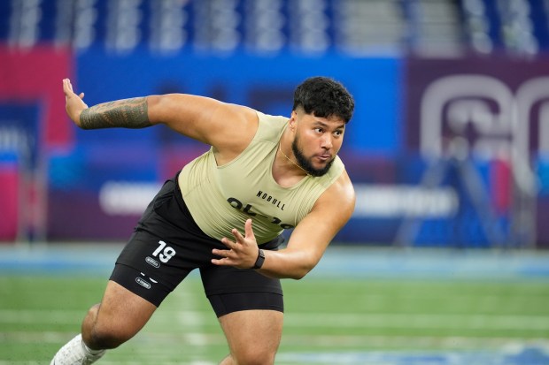 Washington offensive lineman Troy Fautanu runs a drill at the NFL scouting combine on March 3, 2024, in Indianapolis. (AP Photo/Michael Conroy)