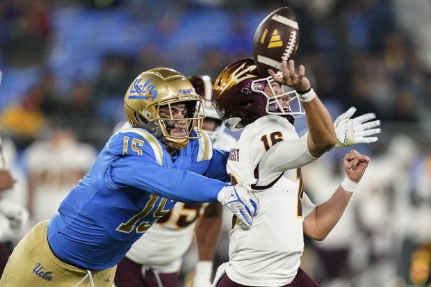 UCLA defensive lineman Laiatu Latu pressures Arizona State quarterback Trenton Bourguet on Nov. 11, 2023, in Pasadena, Calif. (AP Photo/Ryan Sun)