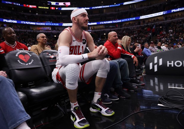 Bulls guard Alex Caruso ends up in the front row of seats during a game against the Blazers on March 18, 2024, at the United Center. (Brian Cassella/Chicago Tribune)