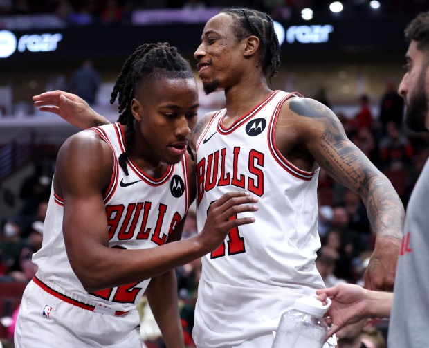 Bulls forward DeMar DeRozan, right, congratulates teammate Ayo Dosunmu at the end of a victory over the Wizards on March 16, 2024, at the United Center. (Chris Sweda/Chicago Tribune)