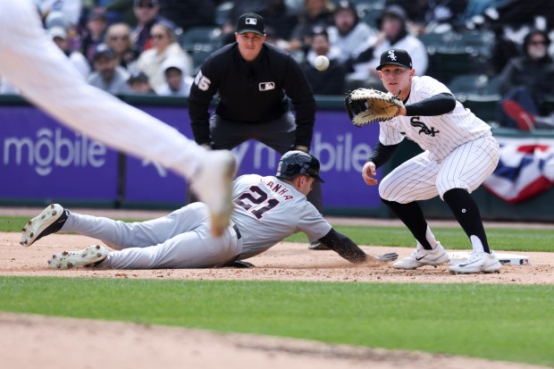 Chicago White Sox first baseman Andrew Vaughn, 25, tries to get Detroit Tigers outfielder Mark Canha out at first base during the fourth inning of the game at Guaranteed Rate Field in Chicago on March 31, 2024. (Eileen T. Meslar/Chicago Tribune)