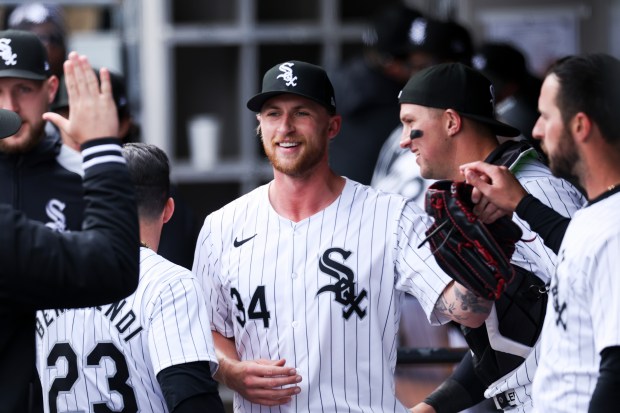 Chicago White Sox pitcher Michael Kopech, 34, gets high-fives from teammates in the dugout during the eighth inning of the game against the Detroit Tigers at Guaranteed Rate Field in Chicago on March 31, 2024. (Eileen T. Meslar/Chicago Tribune)