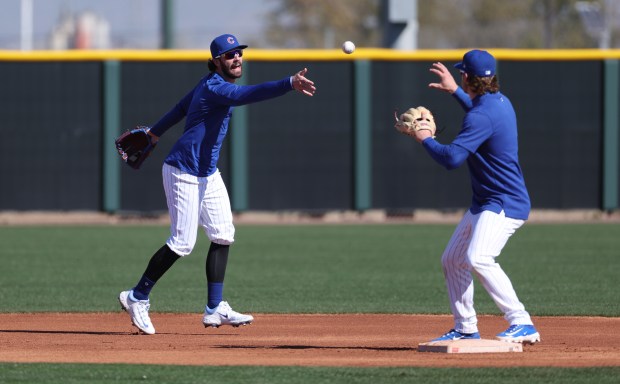 Cubs shortstop Dansby Swanson tosses the ball to second baseman Nico Hoerner at spring training on Feb. 20, 2024, in Mesa, Ariz. (Stacey Wescott/Chicago Tribune)