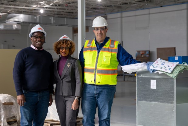 Jesse Green, from left, executive director of the North Lawndale Community Coordinating Council, Patricia Ford, executive director of the Steans Family Foundation, and trustee James Kastenholz inside the warehouse building that is being rehabbed into The Fillmore Center. (Brian Cassella/Chicago Tribune)