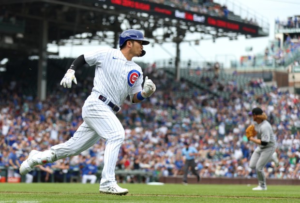 Cubs right fielder Seiya Suzuki sprints down the line after driving in a run with a single against the Rockies on Sept. 22, 2023, at Wrigley Field. (Chris Sweda/Chicago Tribune)