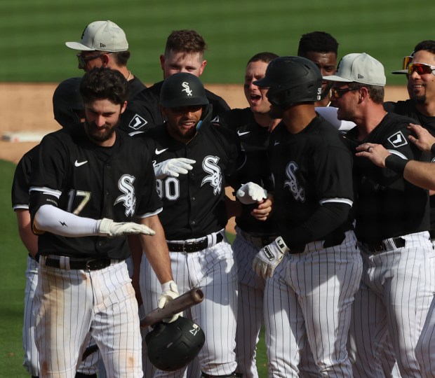 White Sox catcher Edgar Quero is congratulated by his teammates after driving in the winning run in the bottom of the ninth inning against the Mariners on Feb. 24, 2024, in Glendale, Ariz. (Stacey Wescott/Chicago Tribune)