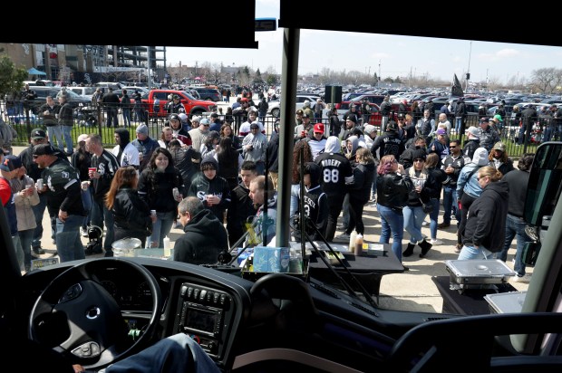 Baseball fans party outside of a bus chartered by the Old Time Tap before the White Sox home opener at Guaranteed Rate Field on March 28, 2024, in Chicago. (Stacey Wescott/Chicago Tribune)
