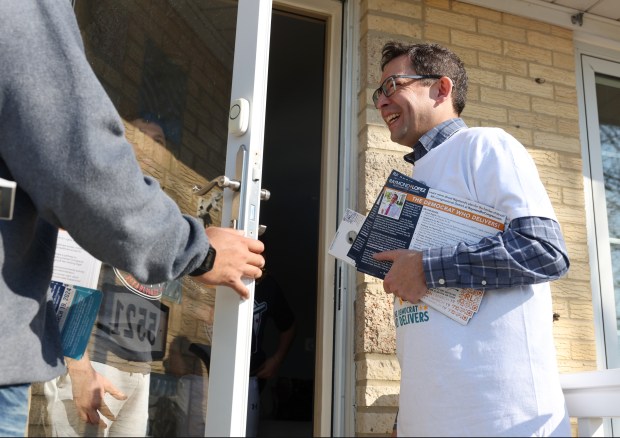 Ald. Raymond Lopez, candidate for U.S. Congress in the 4th District, talks with a prospective voter while canvassing in the 5500 block of South Austin Avenue, March 2, 2024. (John J. Kim/Chicago Tribune)