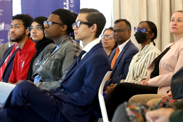 CPS students left to right, Chase Fuller, 17, Fatima Patel,18, Mishal Johnson, 18, and Armando Rodriguez listen to speeches during the announcement of Runway 606, a first-of-its-kind program aimed at providing Chicago Public Schools (CPS) students with a clear, accelerated pathway to high-demand, well-paying careers, during a press conference at the Kapllan Institute, Tellabs Innovation Alley, Illinois Tech Meis Campus in Chicago on Wednesday, March 20, 2024. (Antonio Perez/Chicago Tribune)