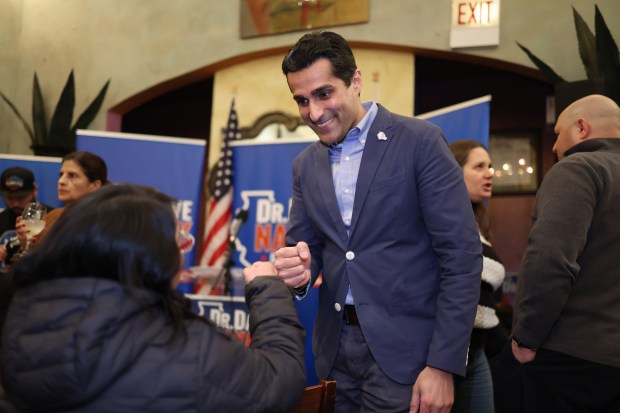 Dr. Dave Nayak, candidate for Illinois Senate 20th District, gives a fist bump to a prospective voter after answering her question during a meet-and-greet at Que Rico restaurant on Feb. 28, 2024, in Chicago. (John J. Kim/Chicago Tribune)