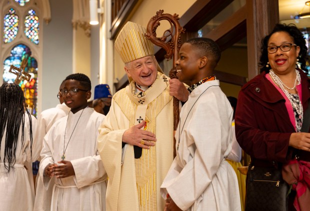 Cardinal Blase Cupich greets church members before conducting an Easter Mass on Sunday, March 31, 2024, at St. Moses the Black Parish in Grand Crossing. (Brian Cassella/Chicago Tribune)