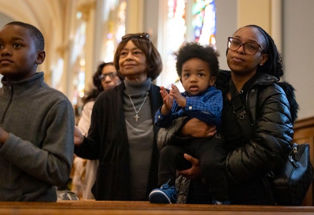 Church members stand during an Easter Mass conducted by Cardinal Blase Cupich on Sunday, March 31, 2024, at St. Moses the Black Parish in Grand Crossing. (Brian Cassella/Chicago Tribune)