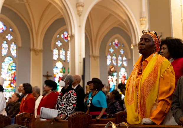 Church members stand during an Easter Mass conducted by Cardinal Blase Cupich on Sunday, March 31, 2024, at St. Moses the Black Parish in Grand Crossing. (Brian Cassella/Chicago Tribune)