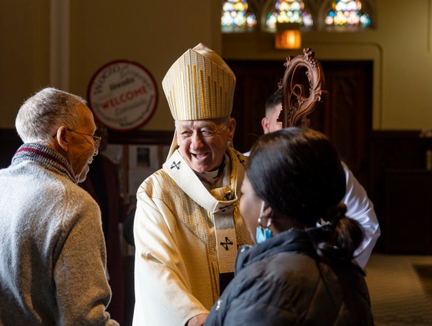 Cardinal Blase Cupich greets church members after conducting an Easter Mass on Sunday, March 31, 2024, at St. Moses the Black Parish in Grand Crossing. (Brian Cassella/Chicago Tribune)