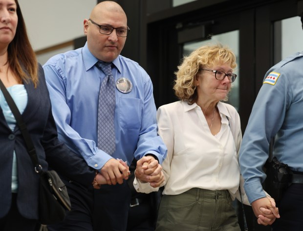 Chicago police Officer Carlos Yanez Jr., center left, and Elizabeth French, mother of slain Chicago police Officer Ella French, center right, exit following closing arguments in the murder trial of her daughter at the Leighton Criminal Court Building on March 5, 2024. Jury deliberations began for Emonte Morgan, who is charged with French's murder during a 2021 traffic stop. Yanez was shot and wounded during the incident. (John J. Kim/Chicago Tribune)