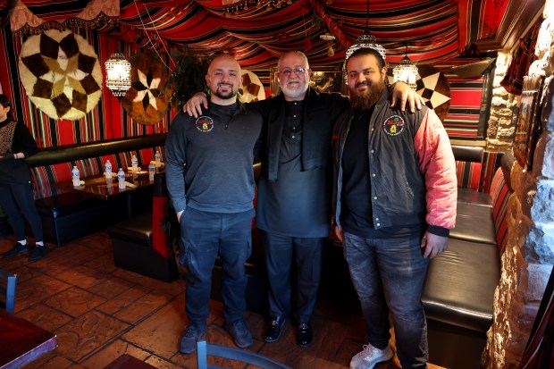 Portrait of Al Bawadi Grill owners Khalil Ismail, center, with sons Hamza Ismail, left, and Faris Ismail, right, at their Bridgeview restaurant during an Iftar while celebrating Ramadan on Friday, March 15, 2024. (Chris Sweda/Chicago Tribune)