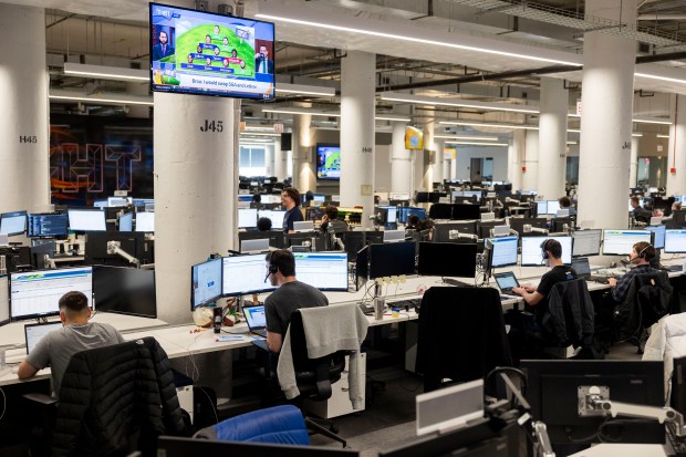 Employees work at their desks in the office space of the Chicago-based tech company, Echo, in the former Groupon building on March 26, 2024. (Vincent Alban/Chicago Tribune)