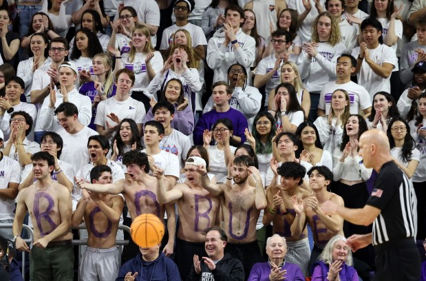 A group of Northwestern students with body paint spelling out the name "Boo Buie" cheer after a basket in the first half against Minnesota on March 9, 2024, at Welsh-Ryan Arena in Evanston. (John J. Kim/Chicago Tribune)