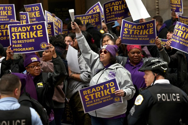 Dozens of Chicago Park District employees and supporters, including Venus Valino, center, rally outside City Hall for better pay on March 26, 2024. The employees are represented by the Service Employees International Union. (Antonio Perez/Chicago Tribune)