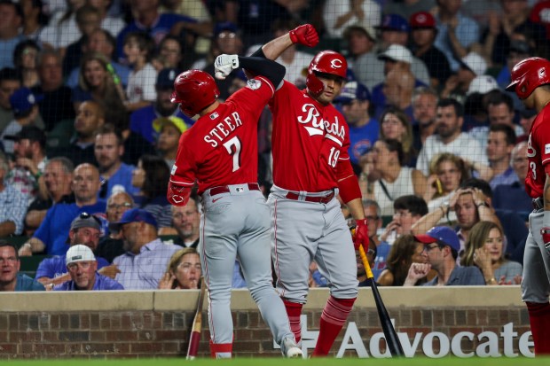 The Reds' Spencer Steer celebrates with Joey Votto after Steer hit a solo home run during the eighth inning against the Cubs at Wrigley Field on Aug. 3, 2023. (Armando L. Sanchez/Chicago Tribune)